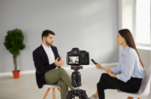Picture of a lady interviewing a man which is being recorded to show an example of an interview video