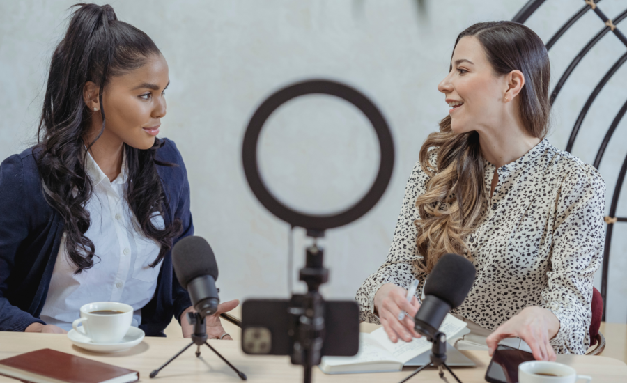 Two women video filming themselves talking together with a smartphone